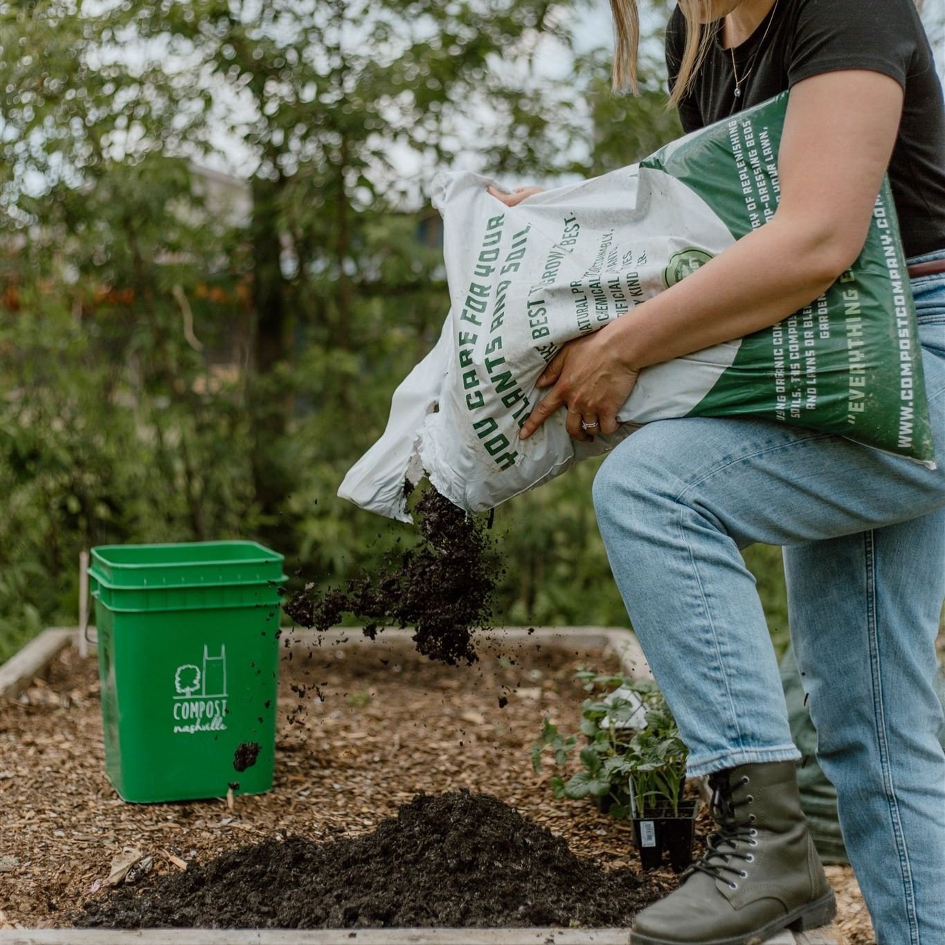 A subscriber holding a bag of finished compost